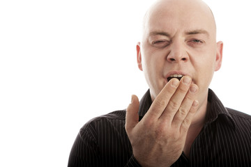 bald man on white background is tired and yawn