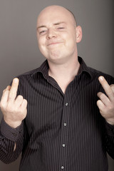 bald man with middel finger