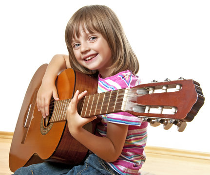 little girl playing guitar - white background
