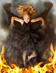 Young dark angel rising from the flames