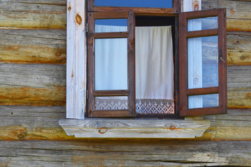 Naklejka na ściany i meble Open window with sun blind in the old wooden house
