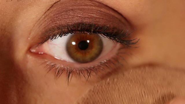 Female eye expression closeup - face powder application