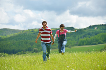Fototapeta premium Portrait of romantic young couple smiling together outdoor