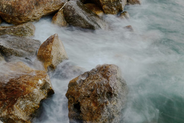 Rocks in the water. Waves Motion blur by long exposure.