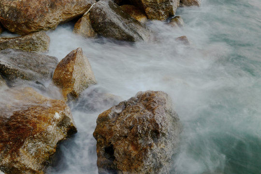 Rocks in the water. Waves Motion blur by long exposure.