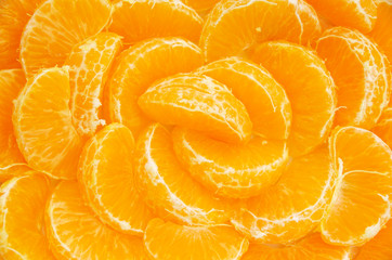 Many orange segments all laid out as a background