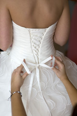 tying the bow on a wedding dress