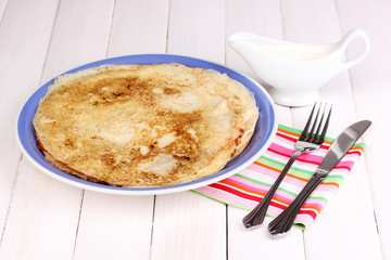 Stack of tasty pancakes on wooden background