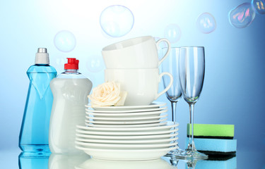 empty clean plates, glasses and cups with dishwashing liquid