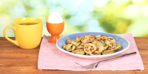 Fried zucchini with eggs and coffee for breakfast