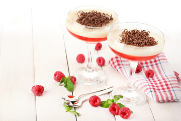 fruit jelly with berries in glasses on wooden table