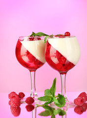 fruit jelly with berries in glasses on pink background