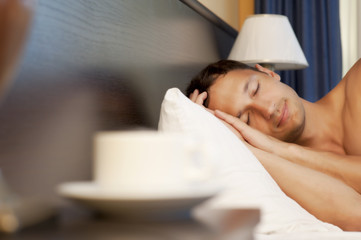 man sleeping on a bed. morning tea