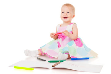 Smiling child draws with color pencils, isolated over white