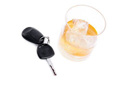 Car key next to a whiskey