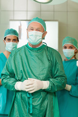Fototapeta na wymiar Surgeon joining his hand with interns behind him