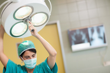 Fototapeta na wymiar Woman holding a surgical light