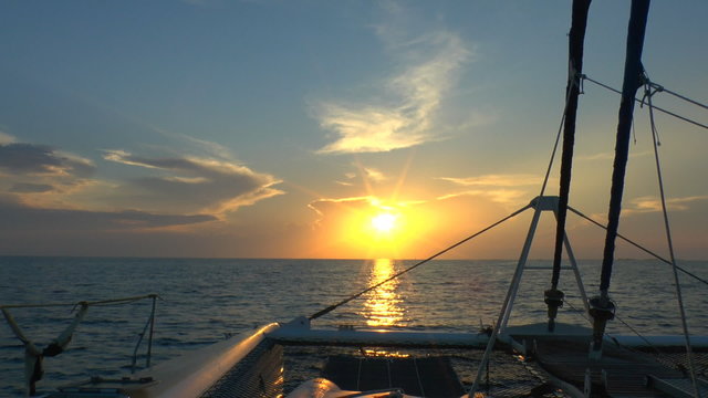 Catamaran, sailing to sunrise, Cuba