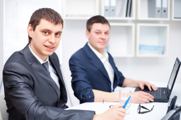 Two young business men working together at office