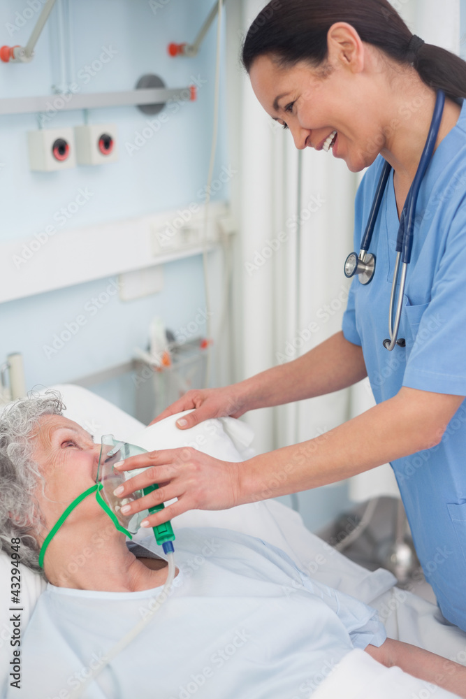 Wall mural Nurse holding an oxygen mask