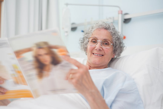 Elderly Patient Reading A Magazine