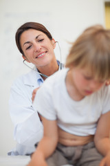 Doctor examining breathing of a child with a stethoscope