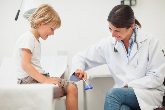 Doctor testing reaction of a child leg