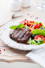 Grilled beef steak with fresh vegetables