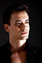 Obraz premium Young masculine handsome man on a black background