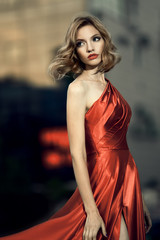 Sexy young beauty woman in fluttering red dress
