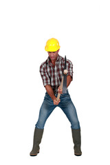Tradesman hacking the ground