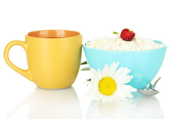 cottage cheese with strawberry in blue bowl and orange cup with