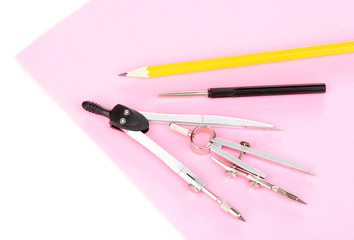Drafting instruments on color paper isolated on white
