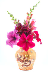 A bouquet of petunias and snapdragons in a vase
