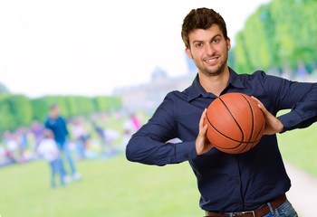 Fototapeta premium Portrait Of Young Man Holding Basketball