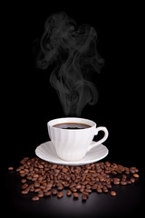 White cup with hot liquid and steam on black