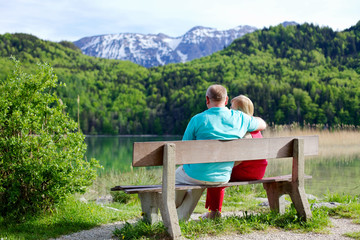 Elderly couple rests on bench