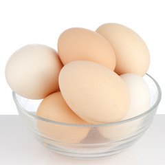 Brown eggs in transparent bowl