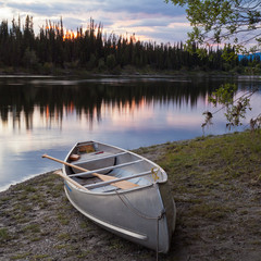 Sunset sky and canoe at Teslin River Yukon Canada
