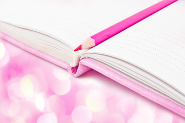 Pink notebook and pencil