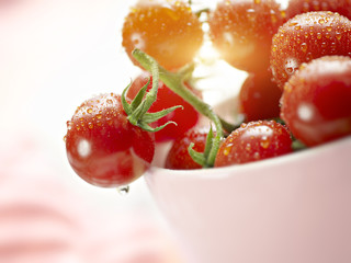Fresh tomatoes with waterdrops in a bowl