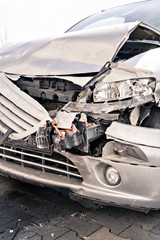 a demolished car after an accident on the street