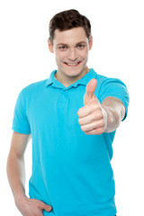 Handsome casual smiling guy showing thumbs up