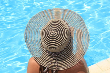 Fototapeta na wymiar Young woman enjoying a swimming pool