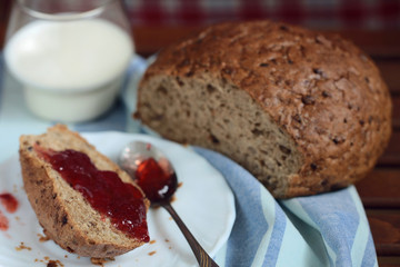 breakfast - bread with strawberry jam and glass of milk