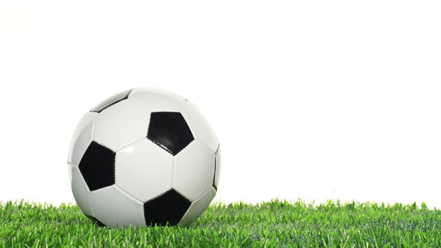 soccer ball on grass cut out from white background
