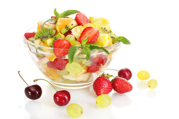 glass bowl with fresh fruits salad and berries isolated on