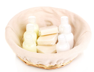 Hotel amenities kit in basket isolated on white