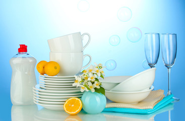 empty clean plates, glasses and cups with dishwashing liquid