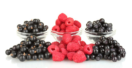 Fresh berries in transparent bowls isolated on white
